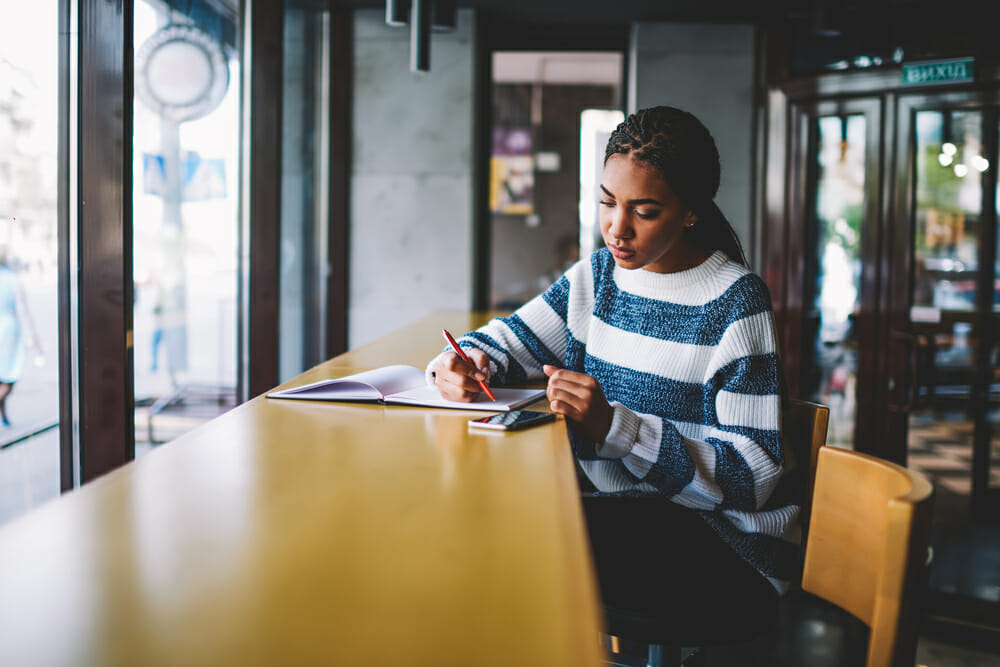 Woman sitting at a table writing